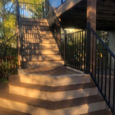 Wood deck stairs with dark railing